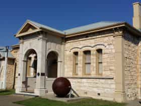Sorrento Museum, a limestone building with a steel ball outside to the right of the door
