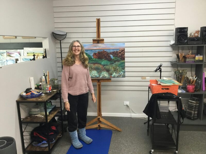 Alexandra in front of her new work space.