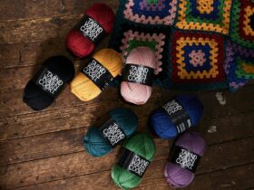 Woollen yarn balls on the shearing shed floor with a crochet rug