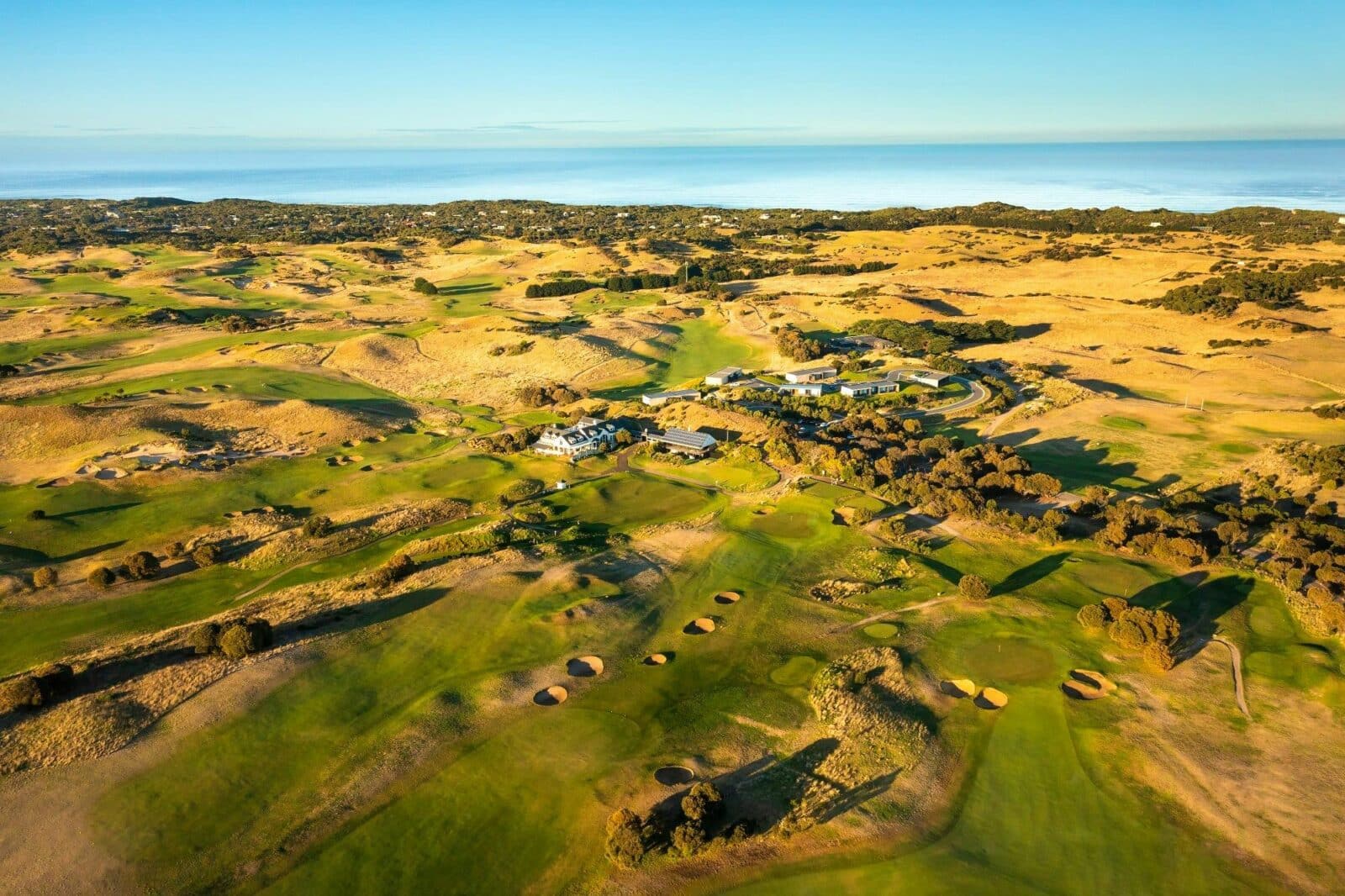 the golf course with the ocean in the background