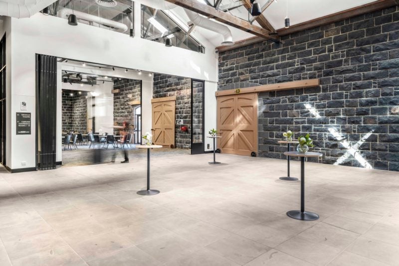 Event space with bar tables, meeting rooms and gorgeous heritage bluestone wall & original barn door