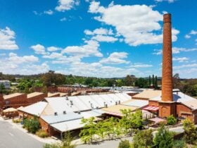 Aerial view looking at variety of old industrial buildings and chimney stack now home to businesses