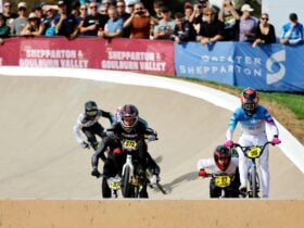 Elite BMX riders race through a berm at Shepparton BMX track
