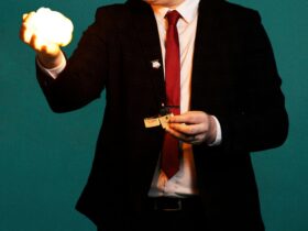 A suit wearing magician with fire ball in his hand