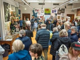 Group of people listening to an artist discussion in After Walter Hopps exhibition