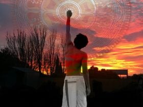 A young man raises his fist to the sky, behind their is a sunset and semi-transparent artwork