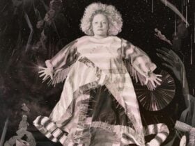 Portrait of Justene Williams in galaxy of props and costumes