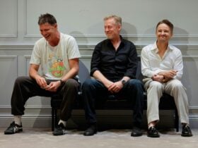 three men sitting on a couch