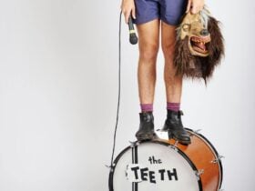 Guy standing on a kick drum with 