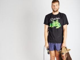 image of guy wearing a Silverchair band t-shirt and holding a microphone and a wolf mask