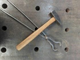 Hammer and tongs on metal surface