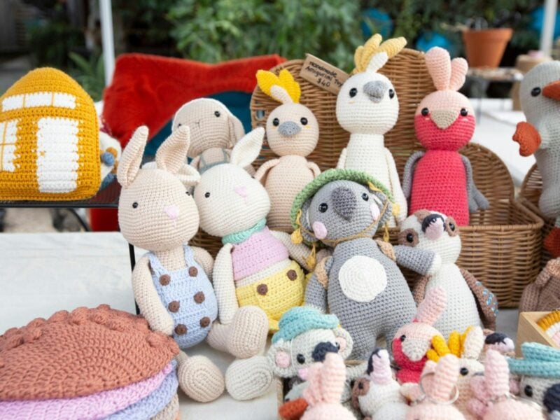 Crocheted toys and clothing crafted by a local maker.