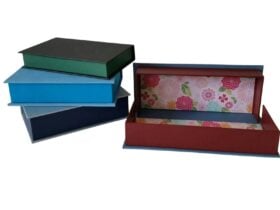 Four cloth covered boxes