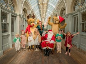 Group of festive characters waving at camera