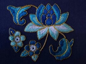 Blue floral embroidery on blue fabric