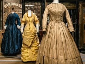 Three historical dresses (blue, gold and light brown) mounted on mannequins