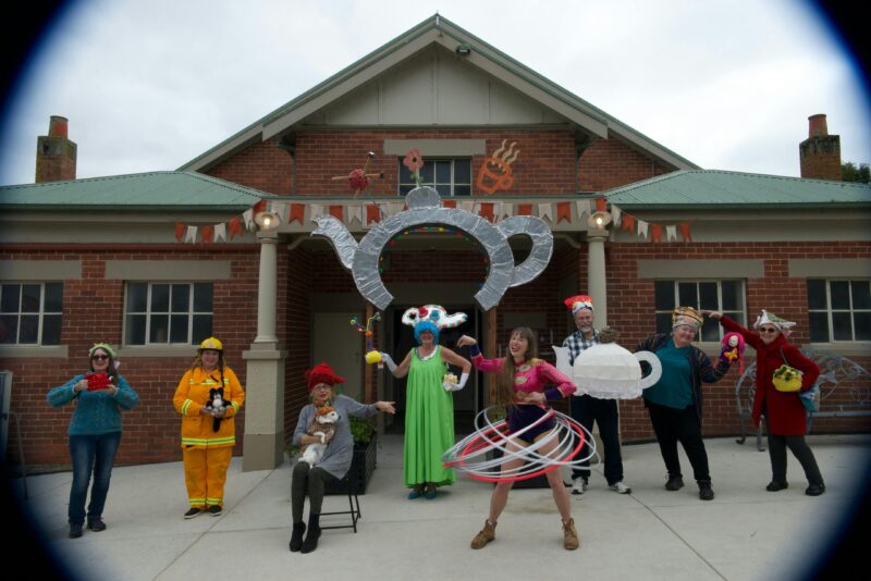 Local community members displaying tea cosy competition entries