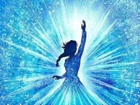 A girl standing with arm outstretched with blue light background.