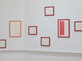 Installation shot of 2023 GAPA winner, salon hang of works with red and orange frames
