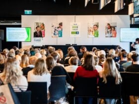 People sitting in chairs in front of a stage for Coeliac Australia