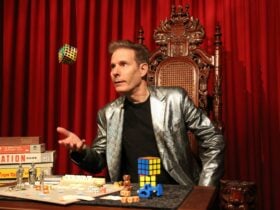 Tim Ellis tossing a rubik cube in the air