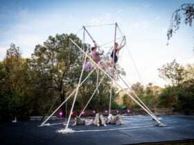 Acrobats on a metal pole rig with ropes