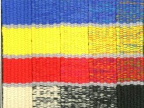 Blue, yellow, red and black diagonal stripped tapestry