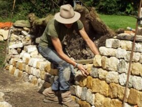 Emma Knowles adding stone to dry stone wall