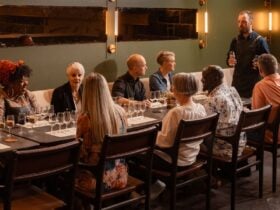 8 people seated with glasses