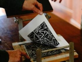an inked plate being pulled