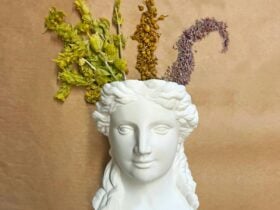 flowers coming out of vase shaped as a woman