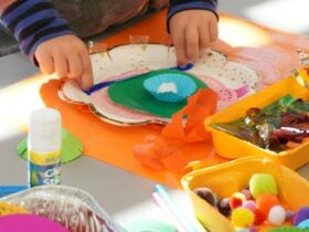 Childs hands making a colourful craft