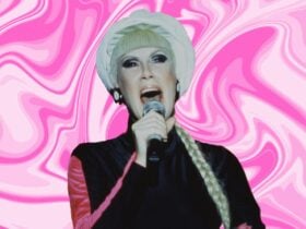 lady stands in sixties costume signing into a microphone