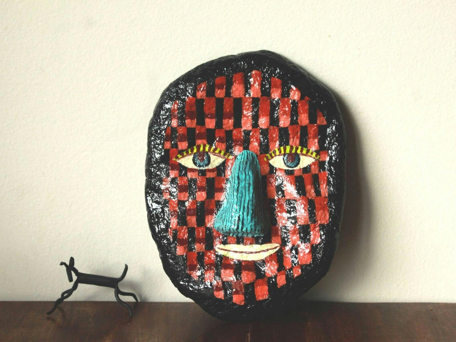 Black white and turquoise papier-mache mask