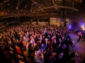 large crowd at the venue facing the stage