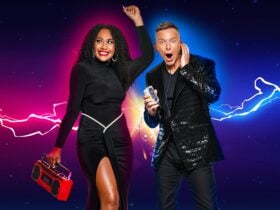Paulini and Tim Campbell posing together holding a boombox and cassette tape.
