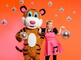 A picture of Pevan & Sarah holding and surrounded by disco balls