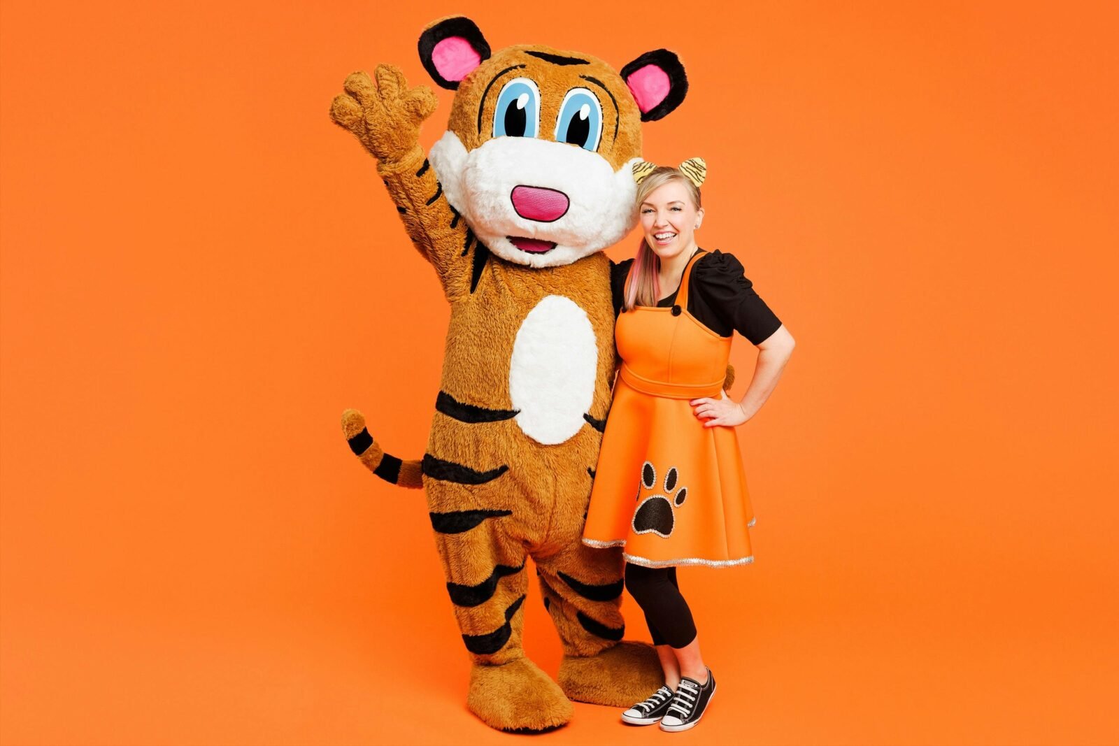 A photo of Pevan & Sarah on an orange background