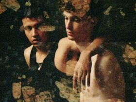 A sepia tone photo of two young men with organic shapes superimposed