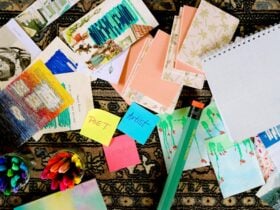 A collection of colourful collages, textas and an oversized pencil, colourful sticky notes.