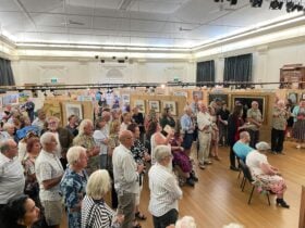 People looking at artworks