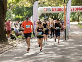 Runners leading the pack at the start of Run2Cure under the neuroblastoma event arch