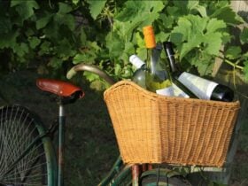 a bike with a wicker basket filled with wine bottles