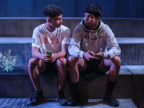 two boys sitting on concrete steps