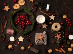 Flat lay photo of Christmas biscuits, spices, dried apple, string and other festive materials