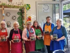 women holding plant pots