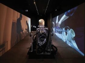 Water and pipe instrument machine in a corridor with projections on either side of the walls.