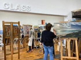 art students painting in spacious art studio