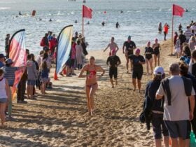 Swimmers exiting the water running to their bikes