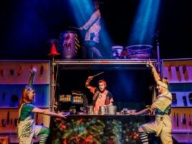 Performers playing drums on pots and pans.